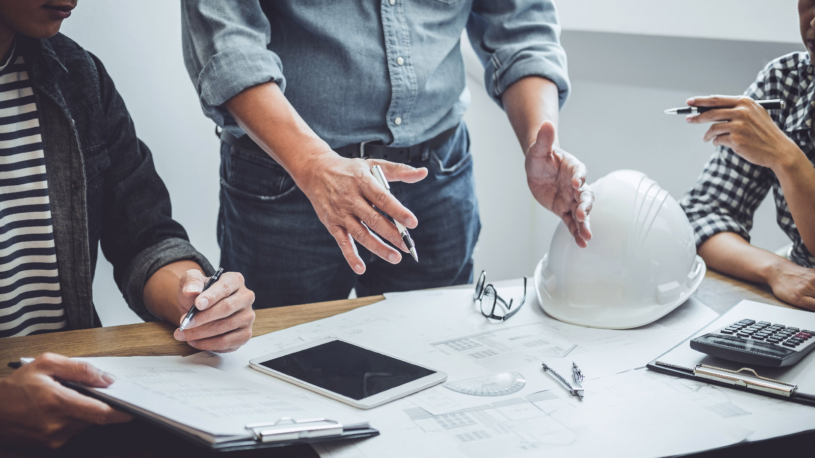 Construction and structure of Engineer or architect meeting for project working with partner and tools on model building and blueprint in working site | Bentley Systems | Infrastructure Engineering Software Company Construction and structure of Engineer or architect meeting for project working with partner and tools on model building and blueprint in working site