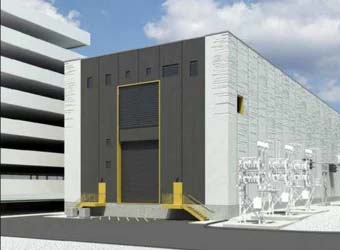 Industrial building with a large bay door, adjacent to a multilevel parking structure. Cloudy sky in the background, perfect for planning electric utilities projects using MicroStation.